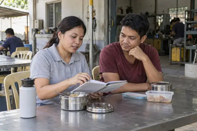 AI-generated scene of workers reviewing a budget during a lunch break in the Philippines